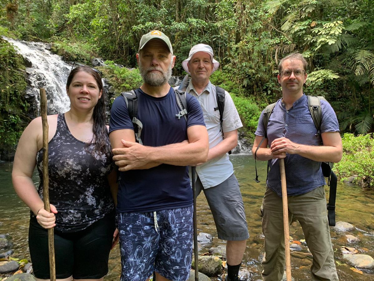 Team photo of FANE; For A New Earth, Directors taken in Sarapiqui, Costa Rica, in front of a waterfall