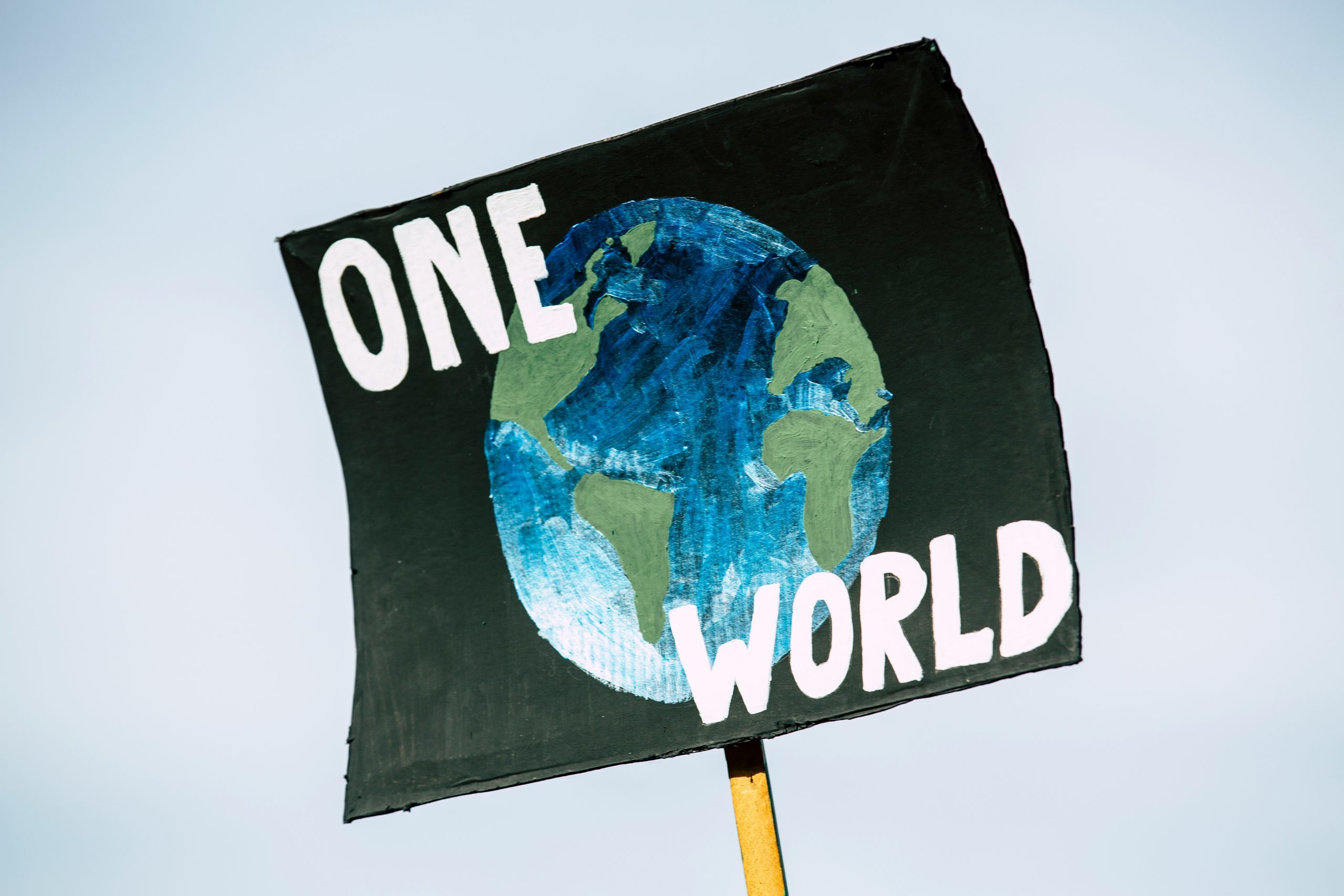 A raised banner stating "ONE WORLD"